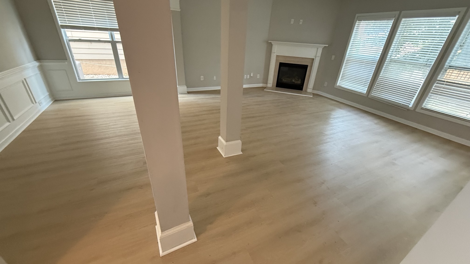 Completed light wood-look flooring installation in a spacious home